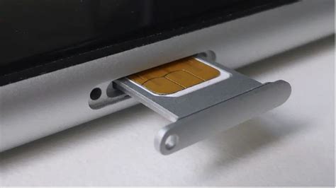 Inserting SIM card on iPhone 5 .